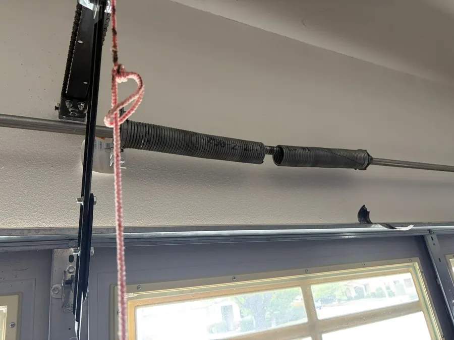 Broken garage door torsion spring before replacement in San Diego