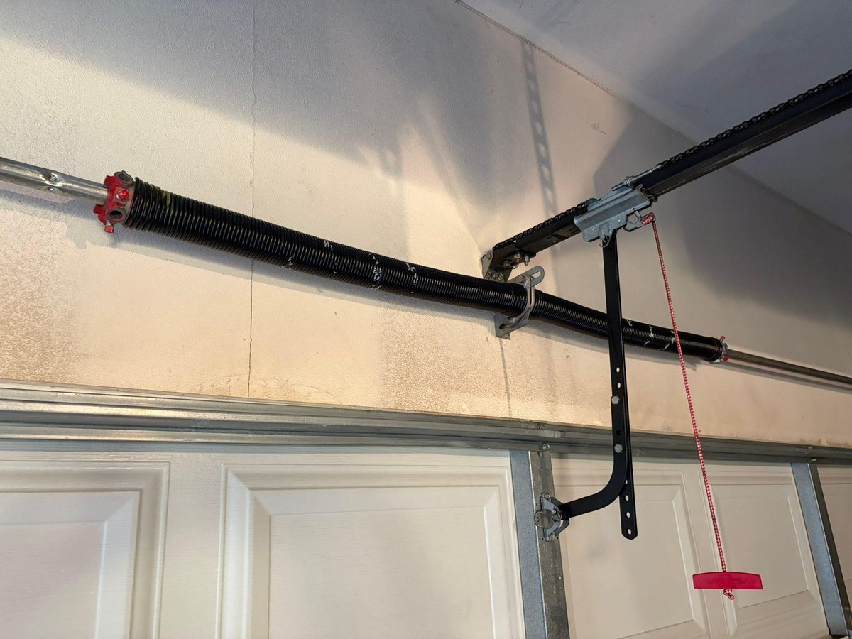 Red manual release cord on a garage door opener, San Diego, by Noah Garage Doors