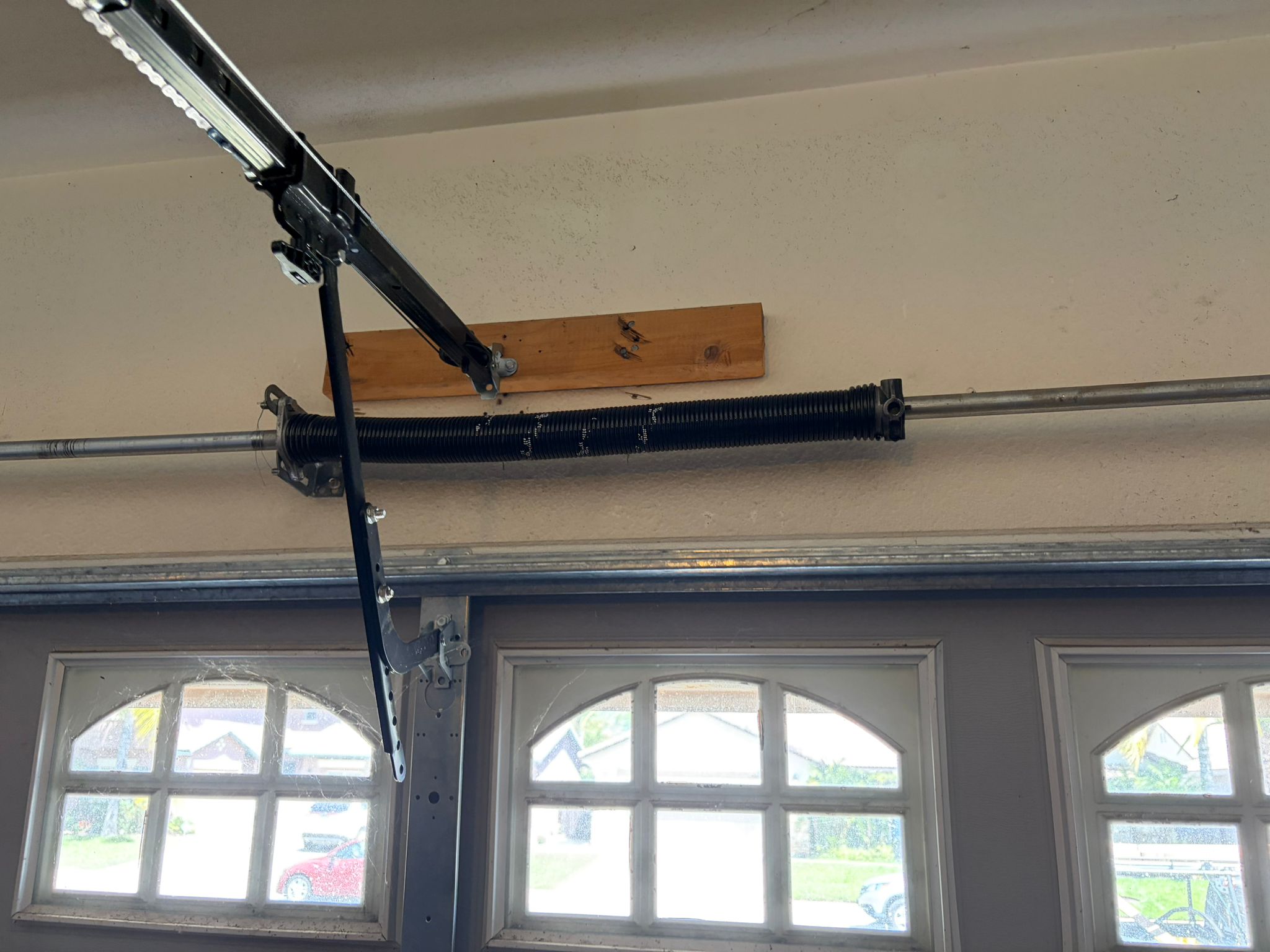 New spring on arched window garage door