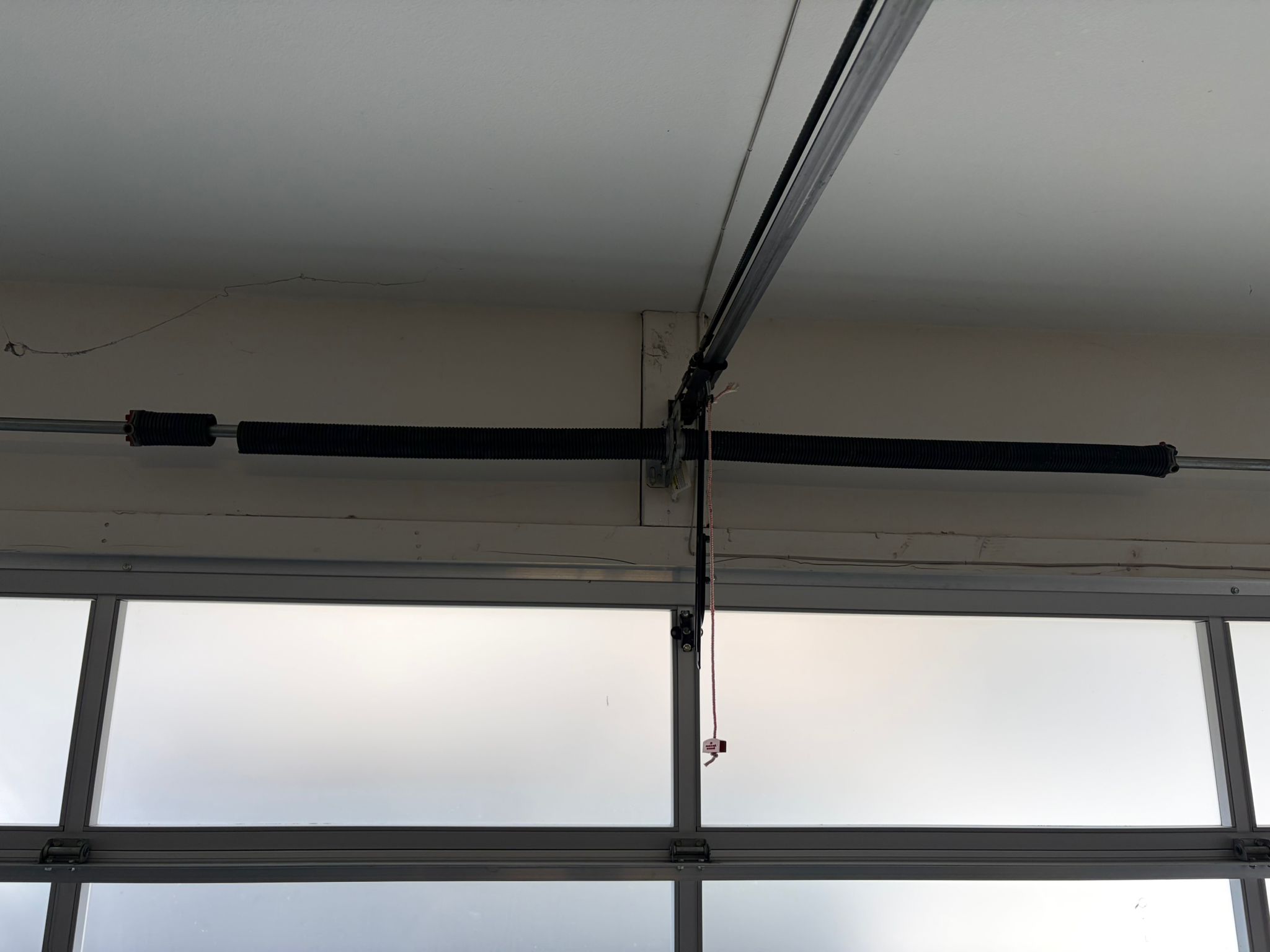 Old spring on glass panel garage door