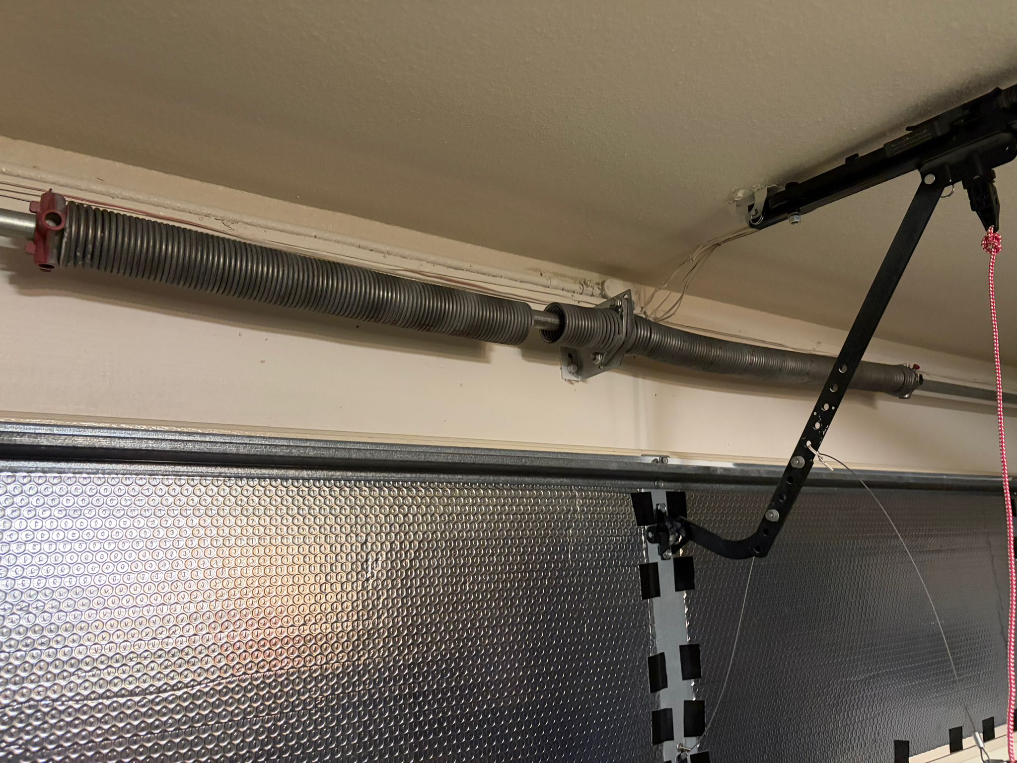 Broken spring on metallic garage door