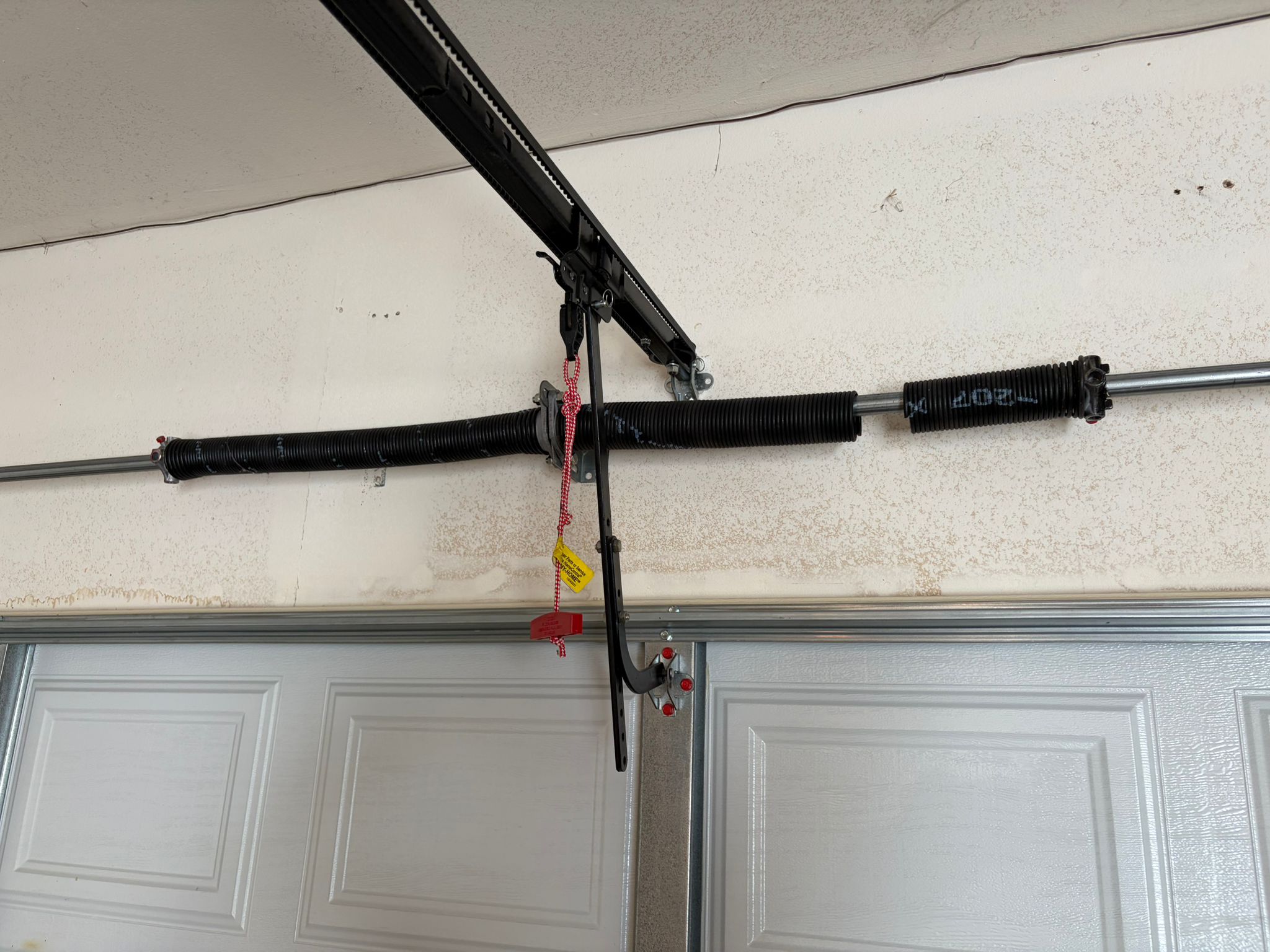 Old garage door spring with service tag