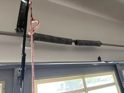 Broken spring on windowed garage door